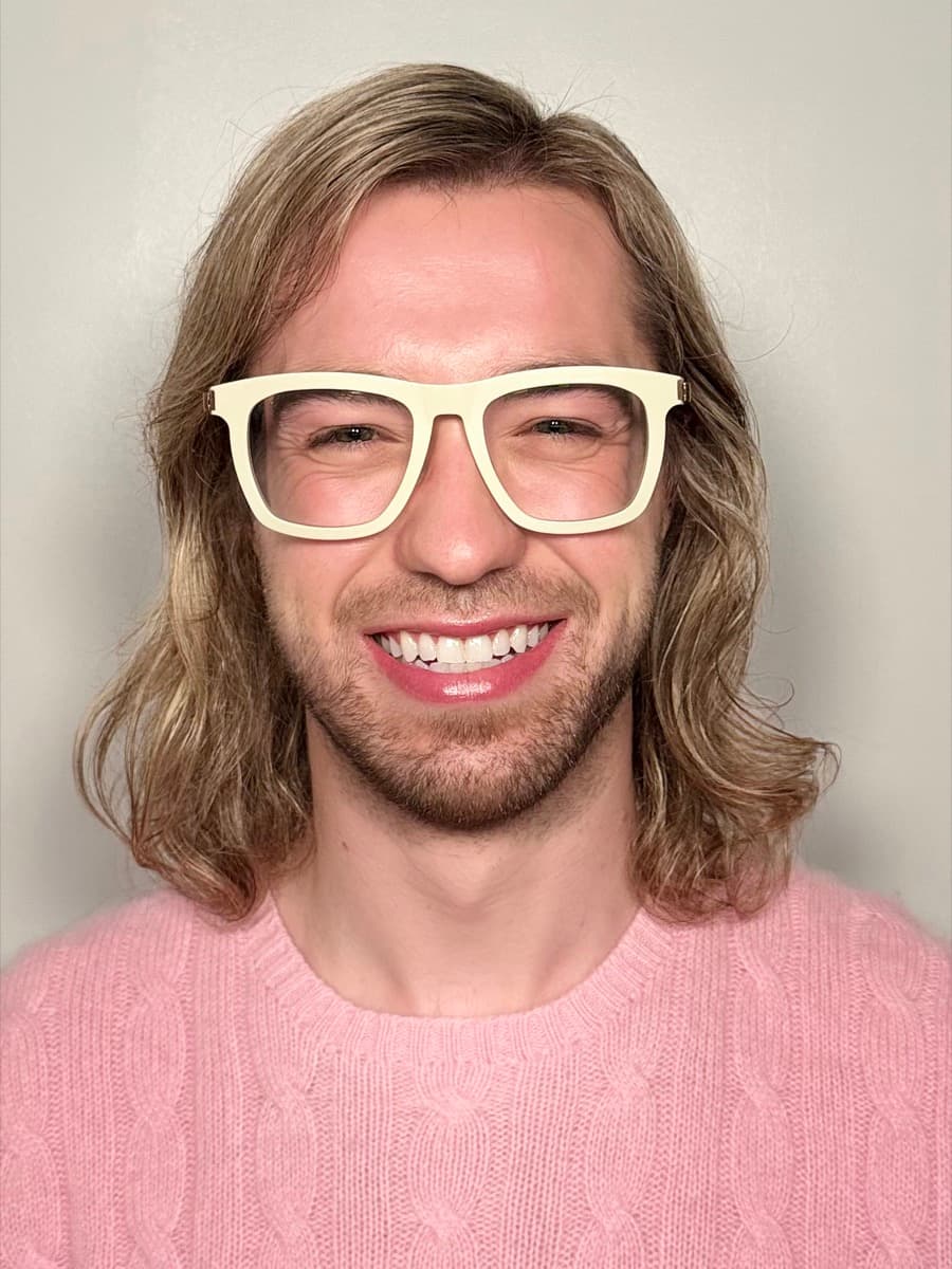 Ryan Watters, LCSW, CADC, smiling in a pink sweater